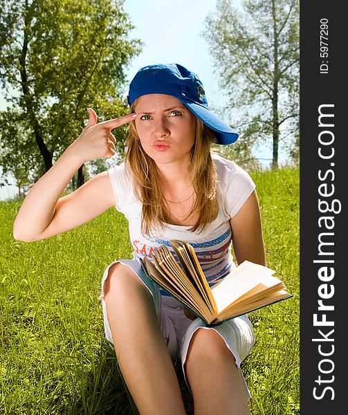 Pretty young girl unwilling to read a book