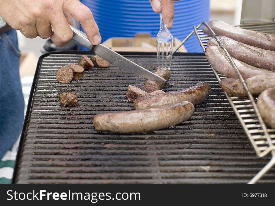 Italian sausages being grilled at a summer barbeque. Italian sausages being grilled at a summer barbeque.