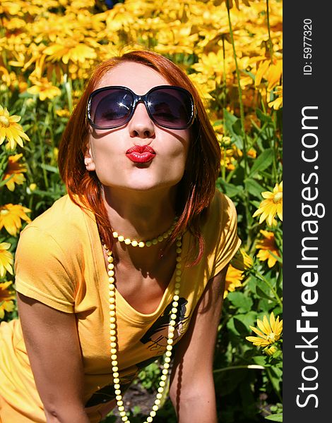 Funny redhead girl with yellow flowers