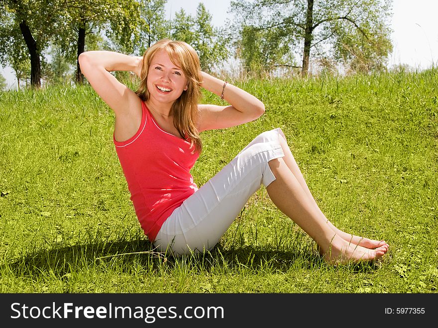 Pretty slim girl working out in the park. Pretty slim girl working out in the park
