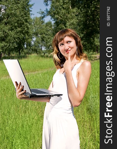 Beautiful young woman with a notebook outdoor. Beautiful young woman with a notebook outdoor