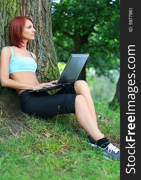 Cute young girl with laptop outdoors. Cute young girl with laptop outdoors