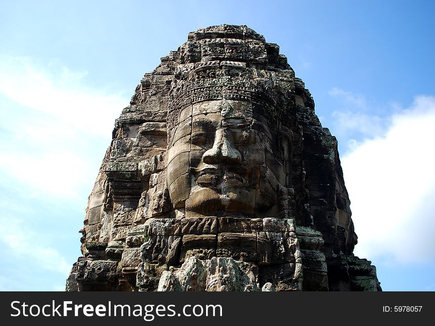 Huge carved face in ruins of temple in Cambodia. Huge carved face in ruins of temple in Cambodia