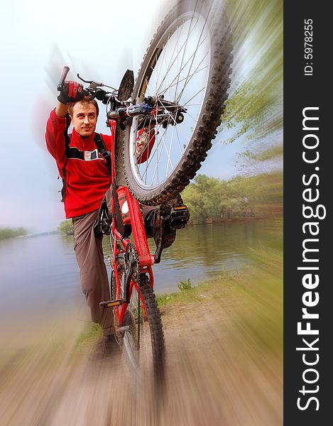 Active cyclist making steep turn on his mountain bike. Active cyclist making steep turn on his mountain bike