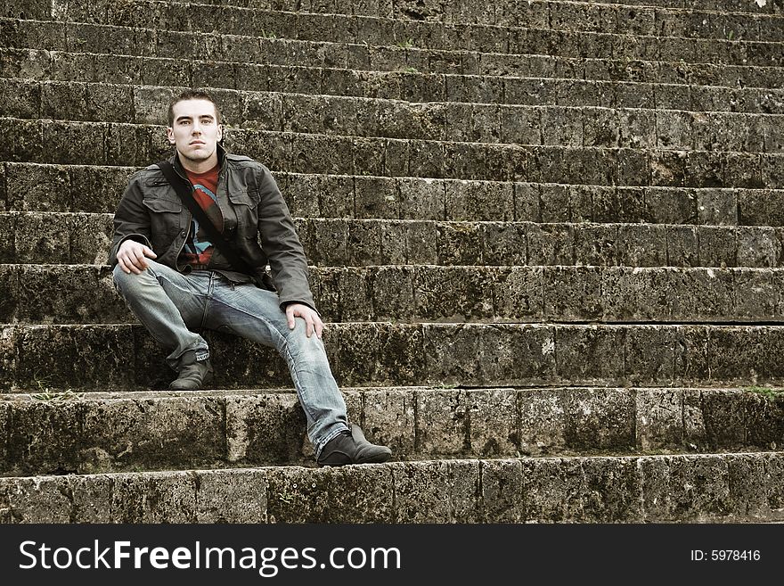 Young guy sitting on stairs