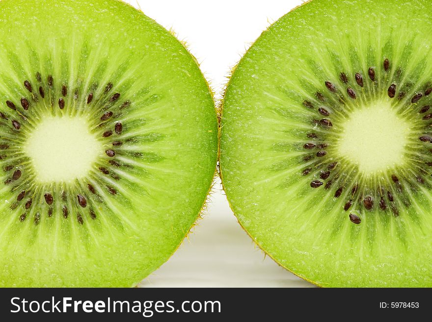 Macro photo of sliced kiwi fruit with seed.