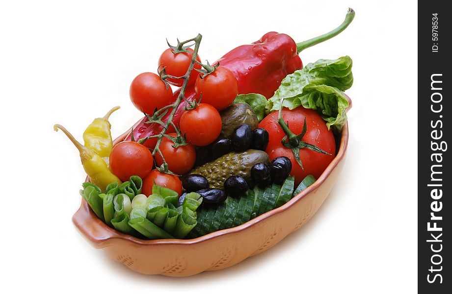 A bowl full of fresh and pickled vegetables isolated on white background. A bowl full of fresh and pickled vegetables isolated on white background.