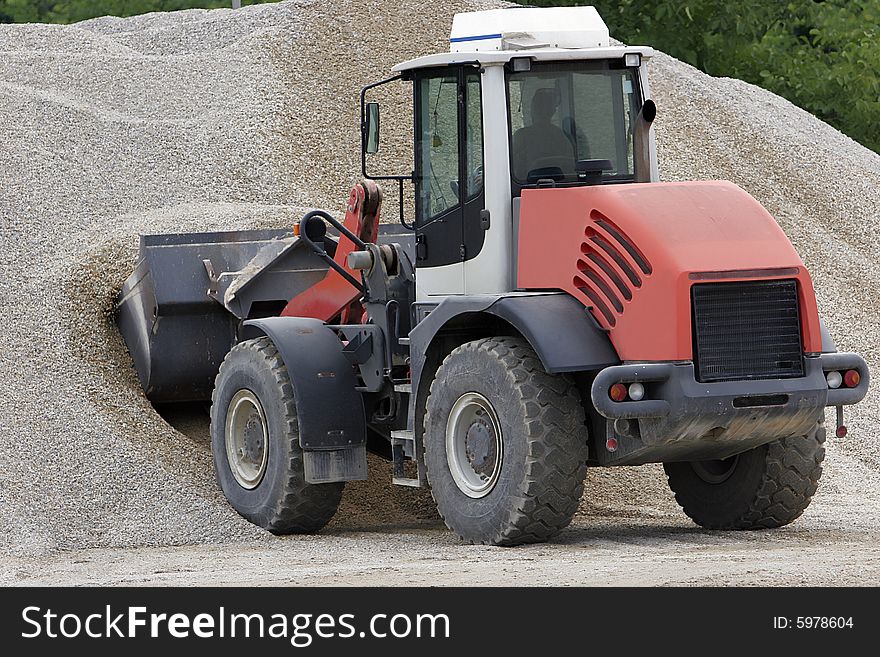 Red bulldozer working at construction site