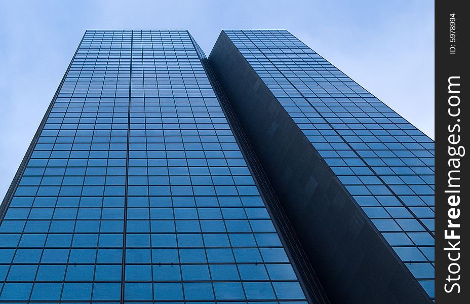 Mirrored skyscraper against blue sky in Boston