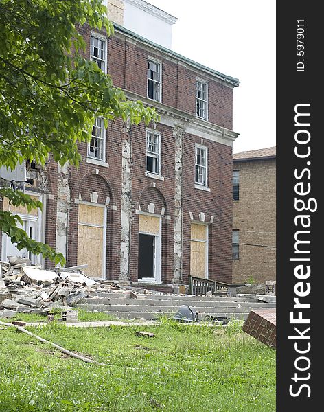 The faï¿½ade of a dilapidated brick building. The faï¿½ade of a dilapidated brick building.