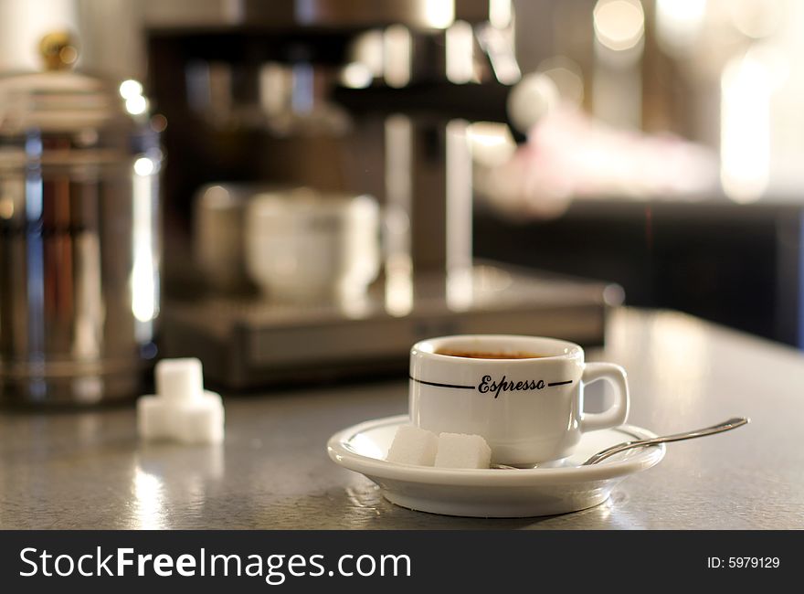 Close-up of a coffee machine and an espresso coffee cup. Close-up of a coffee machine and an espresso coffee cup