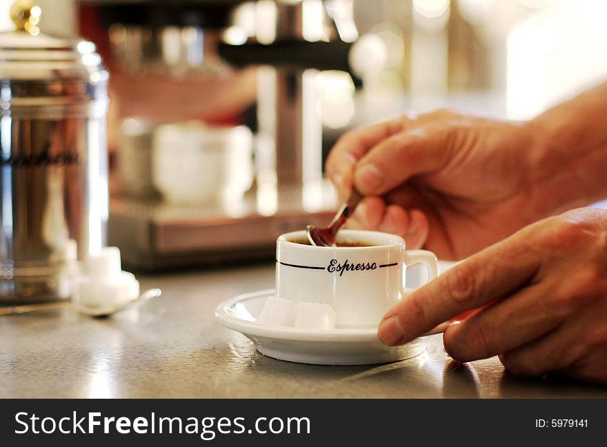 Close-up of a men mixing espresso coffee cup. Close-up of a men mixing espresso coffee cup