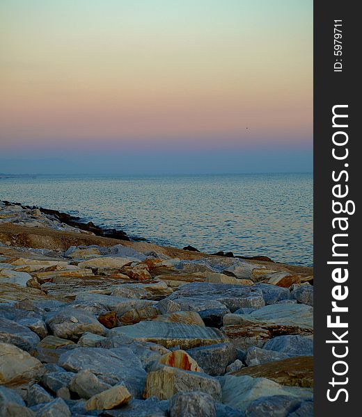 A suggestive shot of rocks and sea at the sunset hour