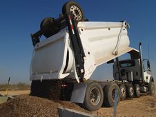 Dump Truck Dumping Dirt - Horizontal Stock Image Dump Truck Dumping Dirt - Horizontal Stock Image