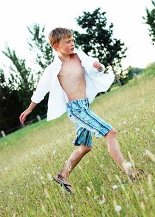 Boy Playing In Grass - Vertical Royalty Free Stock Image