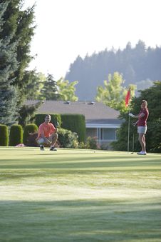 Man And Woman On Golf Course - Vertical Stock Image