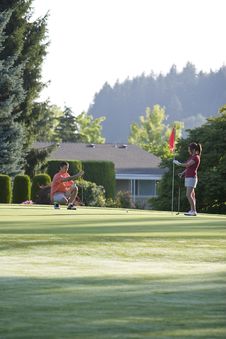 Man And Woman On Golf Course - Vertical Royalty Free Stock Image