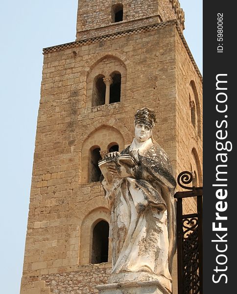 Cathedral of Cefalu (Sicily) with statue at the foreground