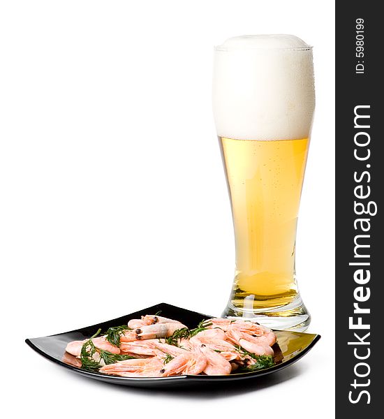 Beer in a glass and a dish with shrimps