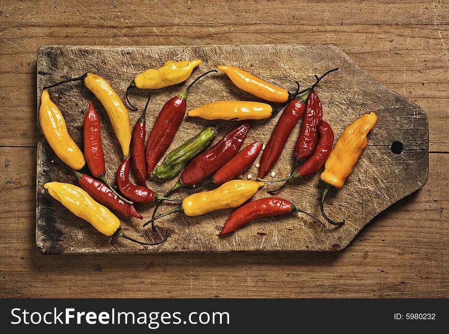 Assorted bolivian chili peppers on cutting table. Assorted bolivian chili peppers on cutting table.