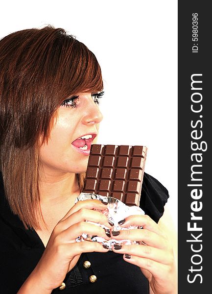 Shot of a pretty young woman about to eat chocolate. Shot of a pretty young woman about to eat chocolate