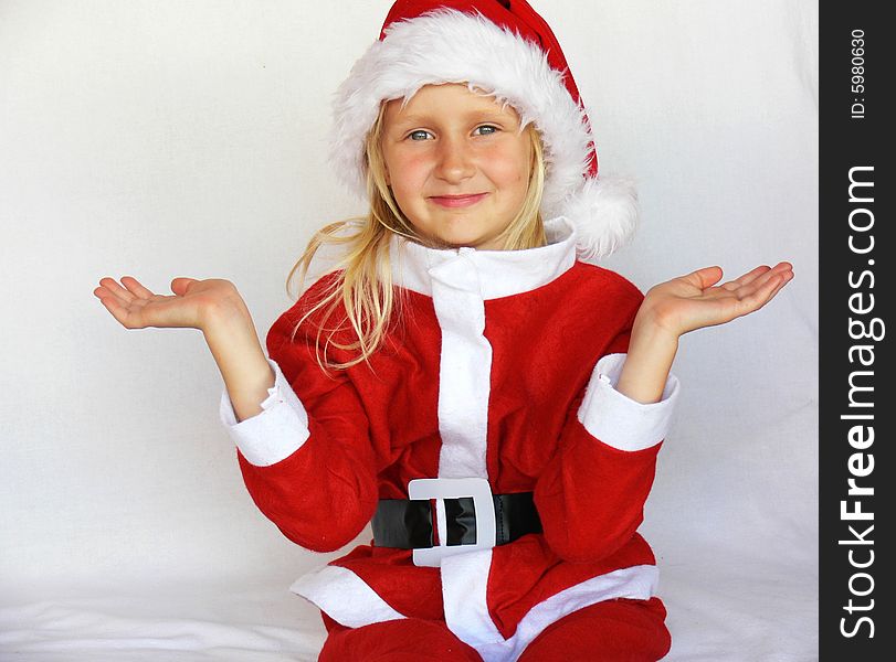 An adorable girl is  wearing a santa dress. An adorable girl is  wearing a santa dress.