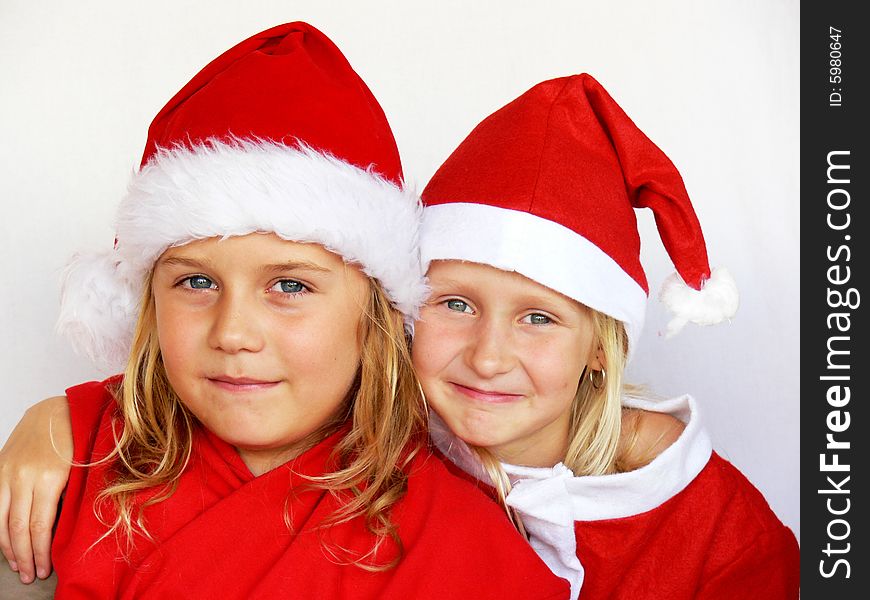 An adorable childrenl wearing a santa dress. An adorable childrenl wearing a santa dress.