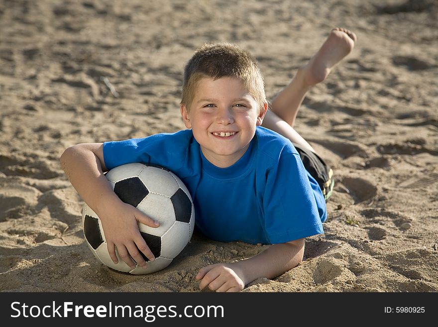 Boy Playing On The Beach