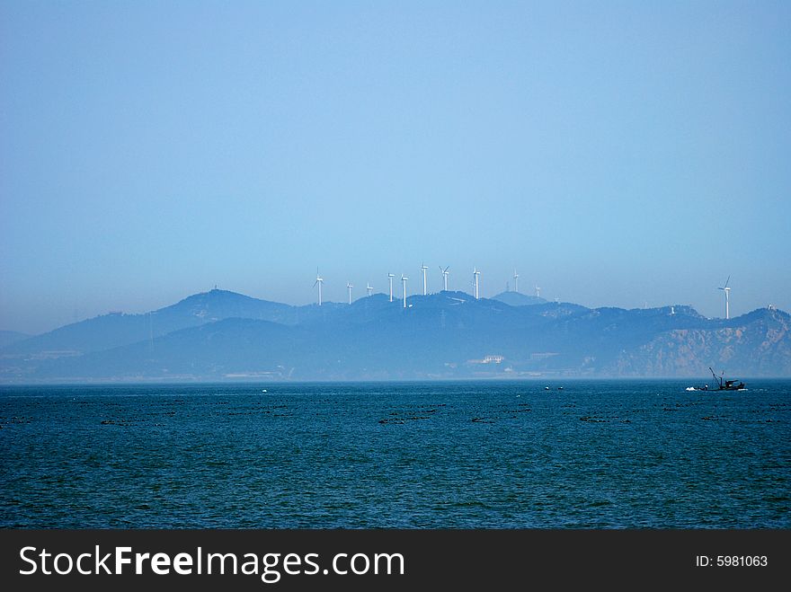 An island with wind turbines, penglai, shandong, china