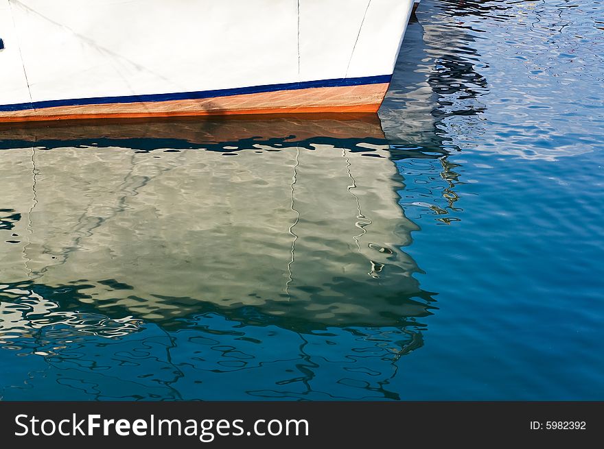 An image of reflection in the water part of ships. An image of reflection in the water part of ships