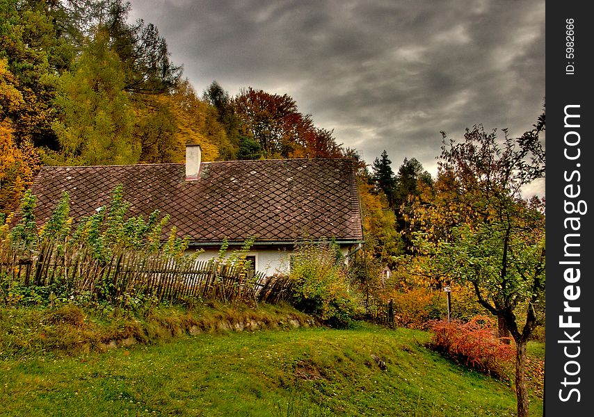 Cottage In Autumn With Dark Sky