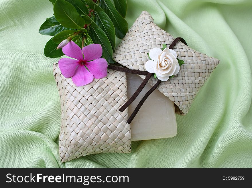 Soap gift in a woven bag with fresh flowers. Soap gift in a woven bag with fresh flowers