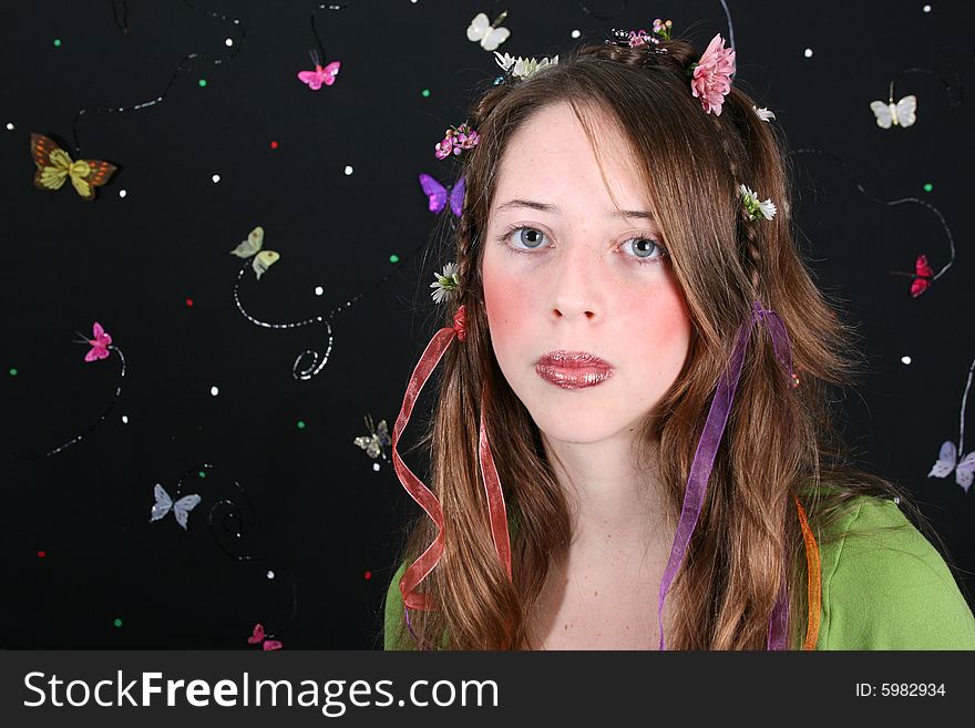 Teenage model with flowers and butterflies in her hair. Teenage model with flowers and butterflies in her hair