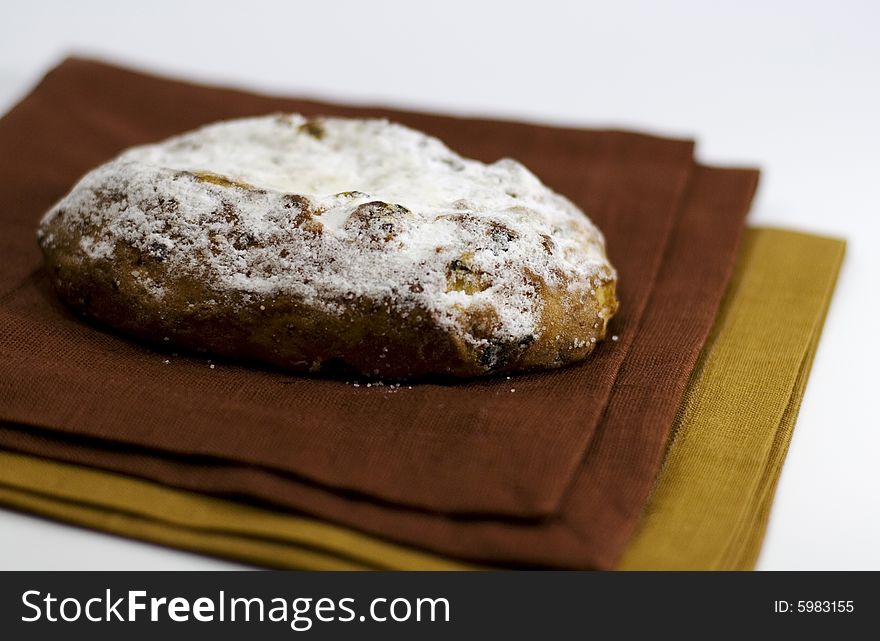 Baked cake with sugar powder on a linen napkin