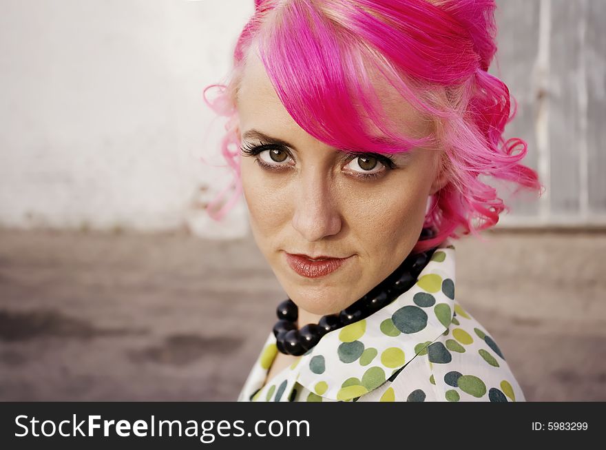 Woman with pink hair in an alley