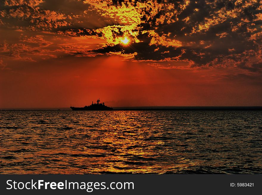 Picturesque decline in the black sea with a silhouette of the ship on horizon. Picturesque decline in the black sea with a silhouette of the ship on horizon