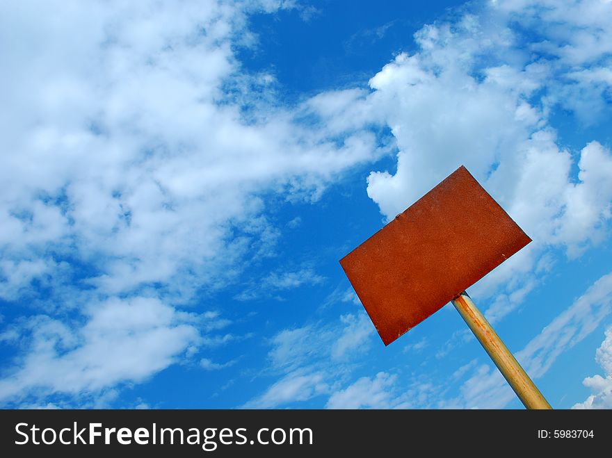 Rusty sign against blue sky