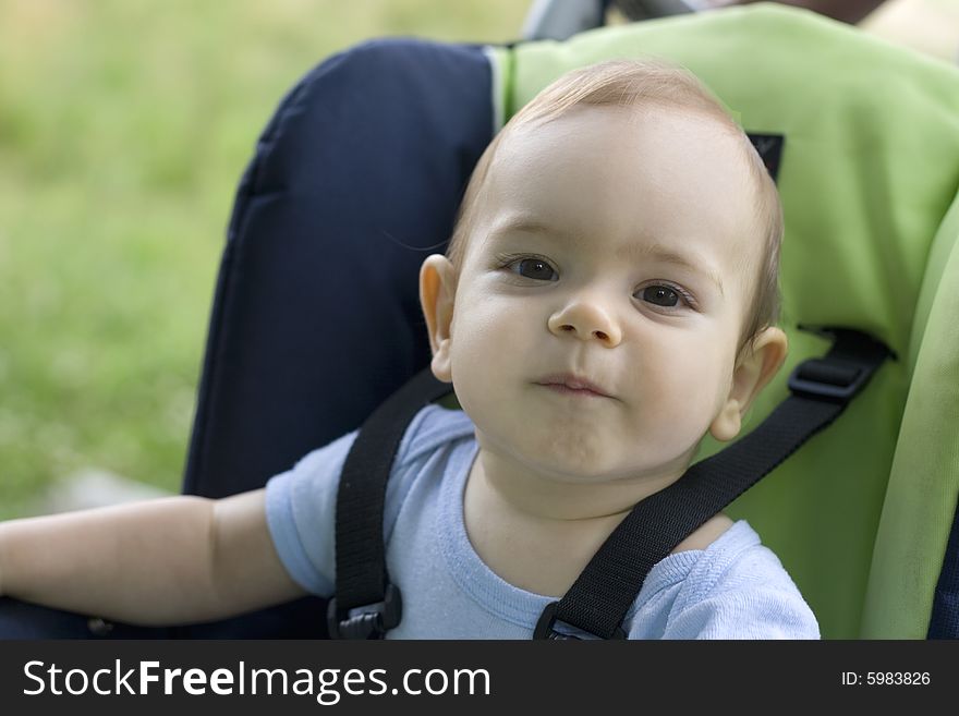 Portrait baby sitting on carriage