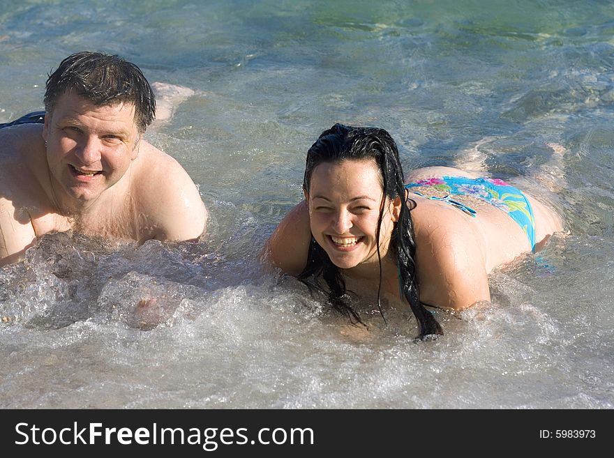 Woman and man on the beach in summer