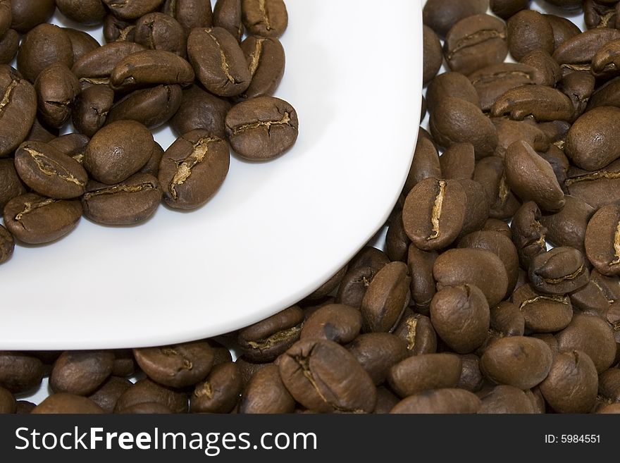 Coffee beans on white dish