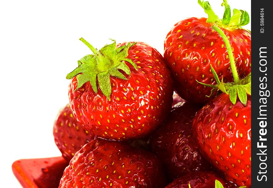 Strawberry on red plate over white background