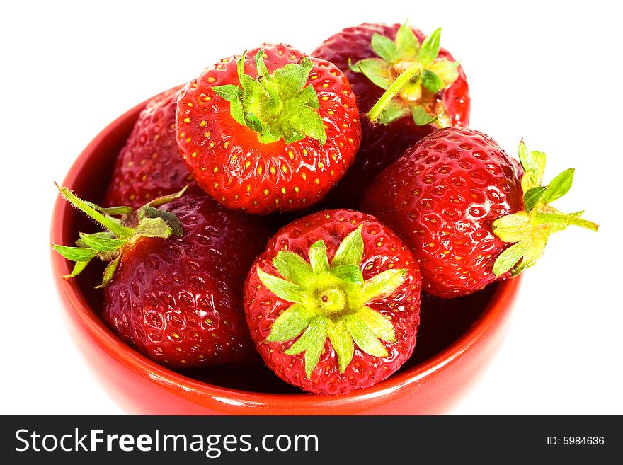 Strawberry on red plate over white background