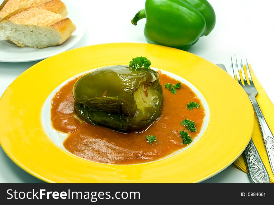 Stuffed pepper with tomato sauce.