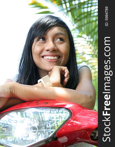 Asian girl on motorcycle smiling. Asian girl on motorcycle smiling