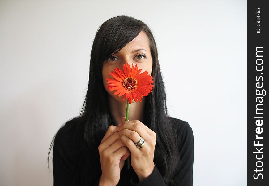 A pretty girl with a orange flower