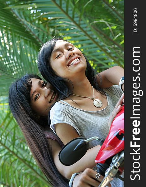 Two girl having fun on motorcycle in nature. Two girl having fun on motorcycle in nature