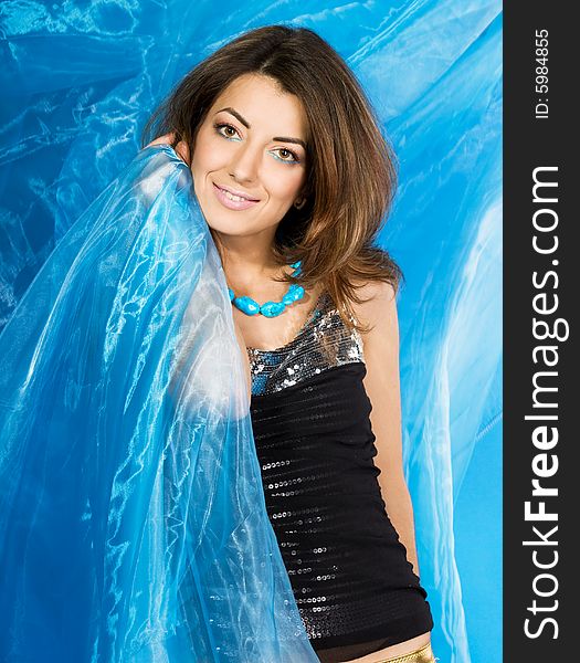 Beautiful woman with blue silk fabric