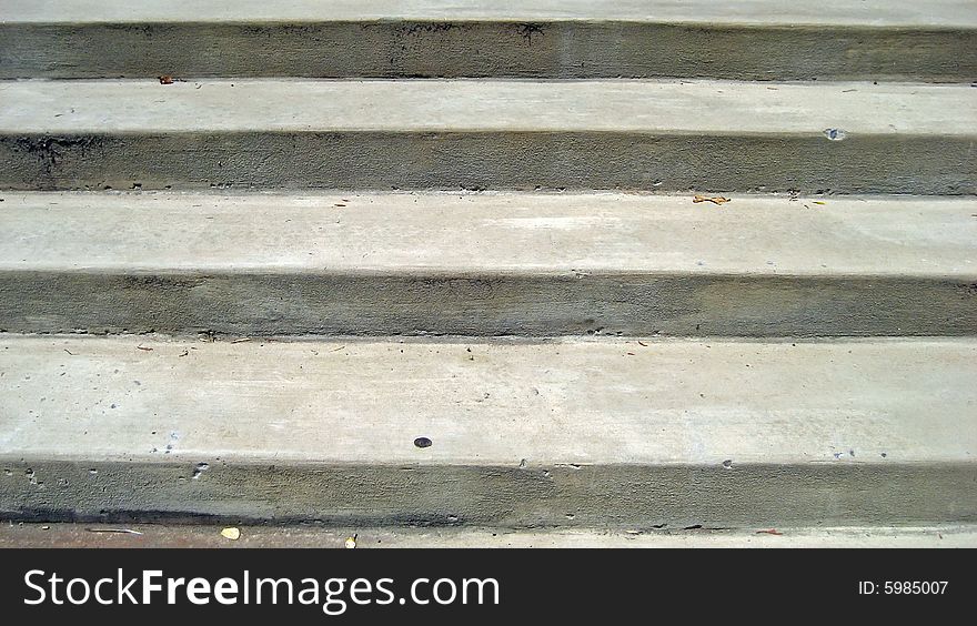 Wide, outdoor concrete steps on a sunny day.