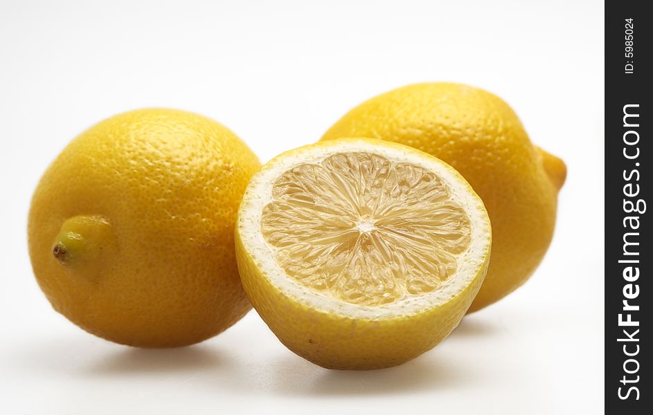 Three lemons citrus isolated fruit yellow half