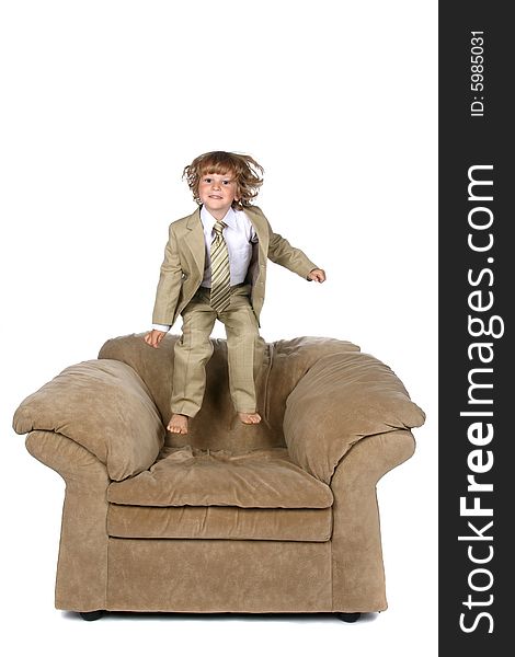 Boy In Suit Jumping On Chair